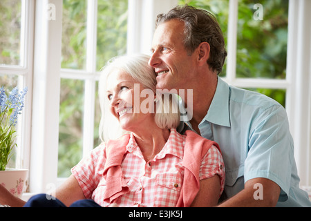 Romantic Middle Aged Couple Looking Out Of Window Stock Photo