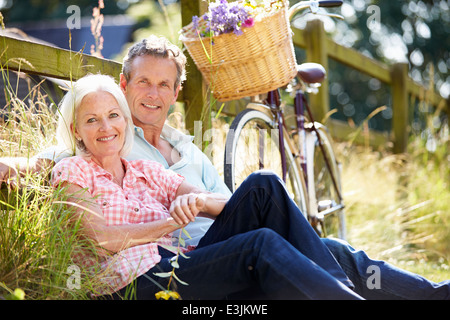 Middle Aged Couple Relaxing On Country Cycle Ride Stock Photo