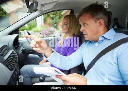 Teenage Girl Having Driving Lesson With Instructor Stock Photo