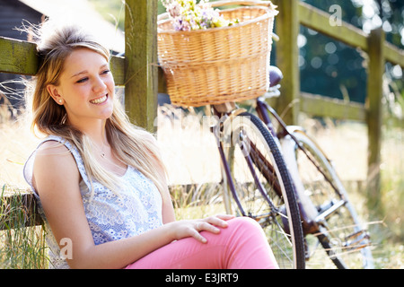 Teenage Girl Relaxing On Cycle Ride In Countryside Stock Photo