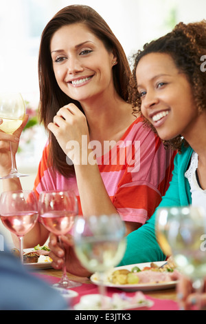 Two Women Relaxing At Dinner Party Stock Photo