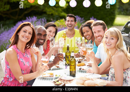 Group Of Friends Having Outdoor Barbeque At Home Stock Photo