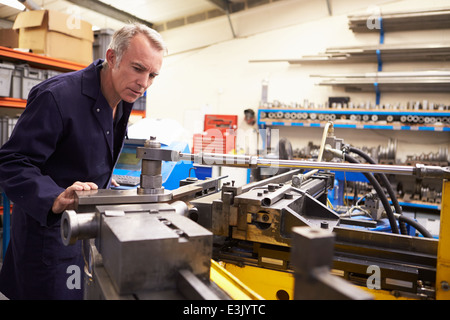 Factory Engineer Operating Hydraulic Tube Bender Stock Photo
