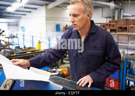 Factory Engineer Operating Hydraulic Tube Bender Stock Photo