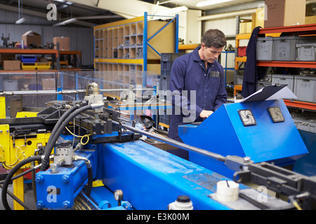 Factory Engineer Operating Hydraulic Tube Bender Stock Photo