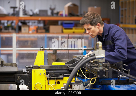 Factory Engineer Operating Hydraulic Tube Bender Stock Photo