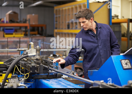 Factory Engineer Operating Hydraulic Tube Bender Stock Photo