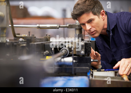 Factory Engineer Operating Hydraulic Tube Bender Stock Photo