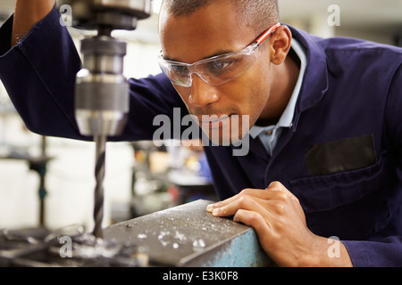 Apprentice Engineer Using Milling Machine Stock Photo