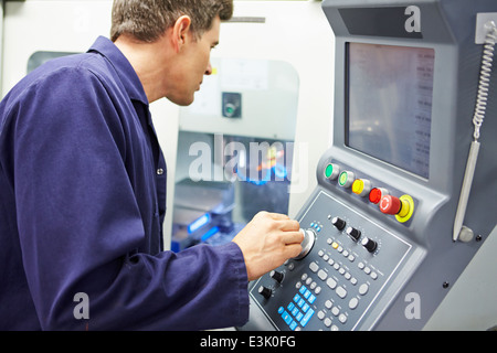 Engineer Operating Computer Controlled Milling Machine Stock Photo