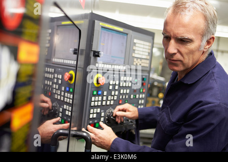 Engineer Operating Computer Controlled Lathe Stock Photo