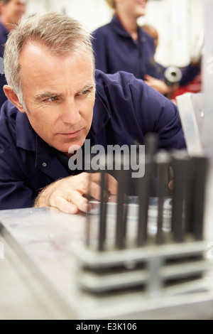 Engineer Studying Component In Workshop Stock Photo