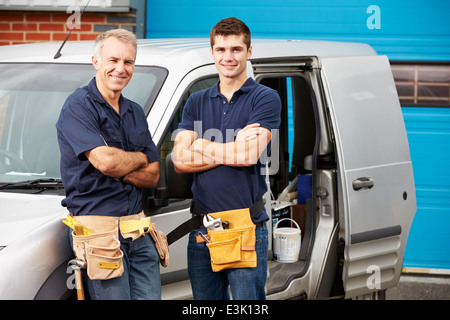 Workers In Family Business Standing Next To Van Stock Photo