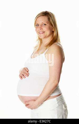 Studio Portrait Of Pregnant Woman Wearing White Stock Photo
