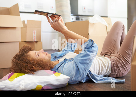 Woman Taking A Break With Digital Tablet In New Home Stock Photo