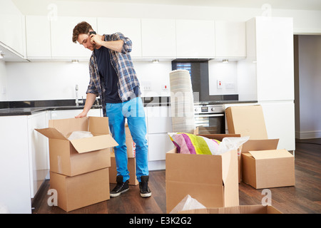 Man Moving Into New Home Talking On Mobile Phone Stock Photo