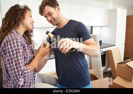 Couple Celebrating Moving Into New Home With Champagne Stock Photo