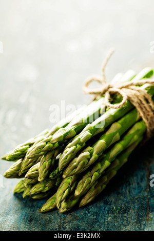 Bunch of fresh asparagus on wooden table Stock Photo