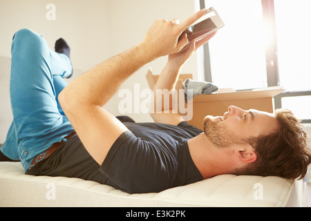 Man Moving Into New Home Using Digital tablet Stock Photo