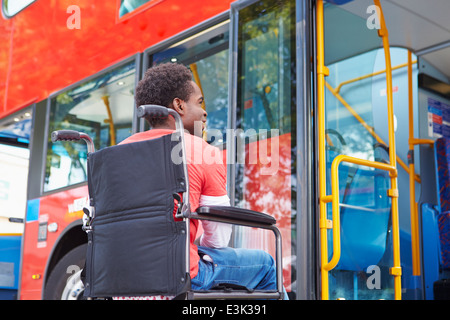 Disabled Man In Wheelchair Boarding Bus Stock Photo
