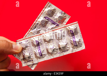 Modafinil, Modalet 200 tablets or pills on a bright red background. Stock Photo