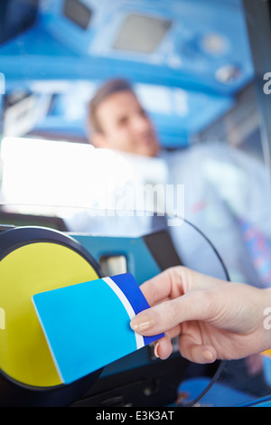 Close Up Of Hand Using Bus Pass For Journey Stock Photo