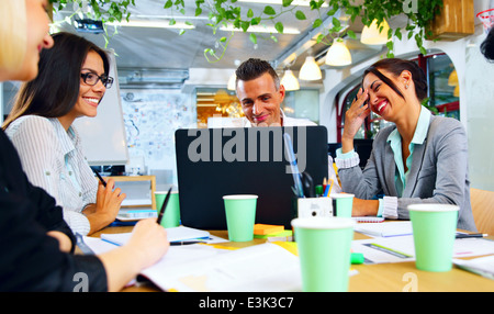 Happy businesspeople working together around the table in office Stock Photo