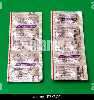 Modafinil, Modalet 200 tablets or pills on a green background. Stock Photo