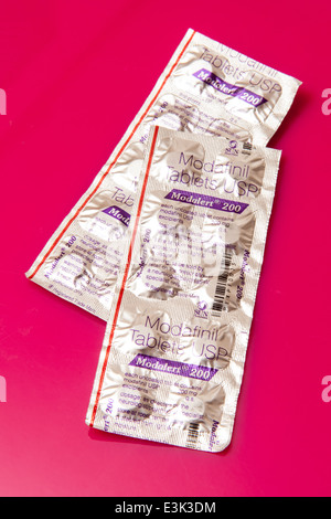 Modafinil, Modalet 200 tablets or pills on a bright pink background. Stock Photo