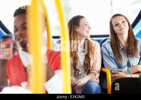 Two Young Women On Bus Journey Together Stock Photo