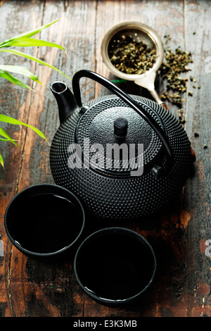 Image of traditional eastern teapot and teacups on wooden desk Stock Photo