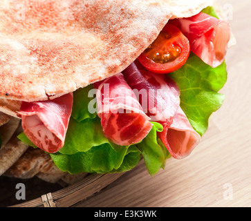 oriental bread with smoked meat and greens. Stock Photo