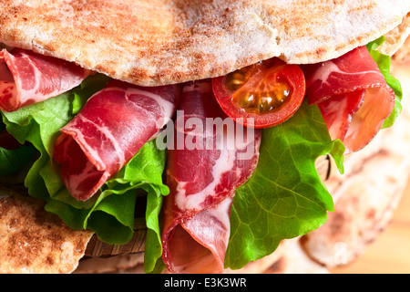 oriental bread with smoked meat and greens. Stock Photo