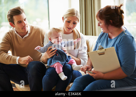 Social Worker Visiting Family With Young Baby Stock Photo