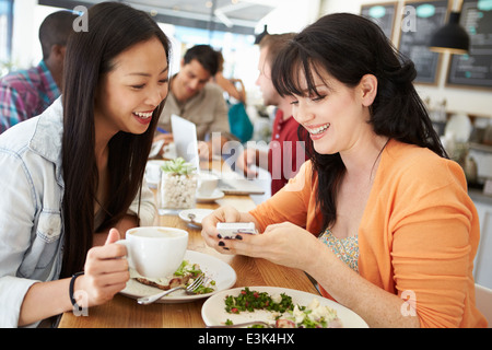 Two Female Friends Friends Meeting For Lunch In Coffee Shop Stock Photo
