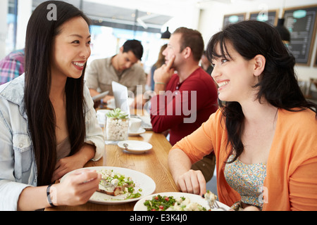 Two Female Friends Friends Meeting For Lunch In Coffee Shop Stock Photo