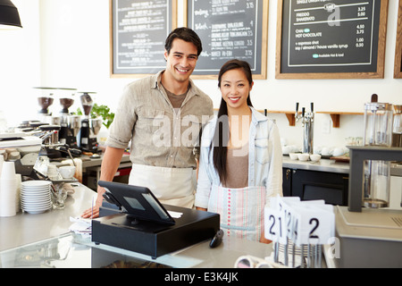 Male And Female Staff In Coffee Shop Stock Photo