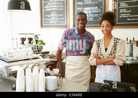 Male And Female Staff In Coffee Shop Stock Photo