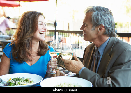 Mature Couple Enjoying Meal At Outdoor Restaurant Stock Photo