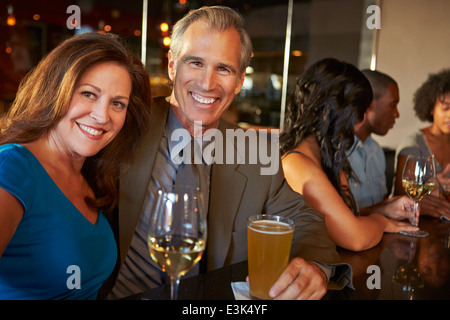 Mature Couple Enjoying Drink In Bar Together Stock Photo