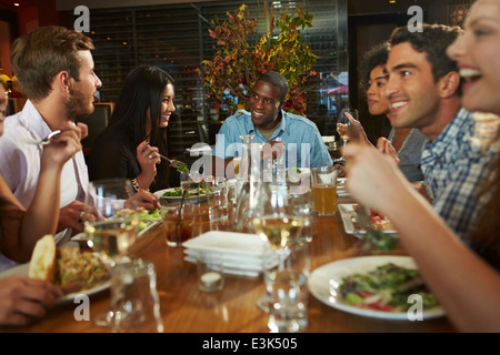 Group Of Friends Enjoying Meal In Restaurant Stock Photo