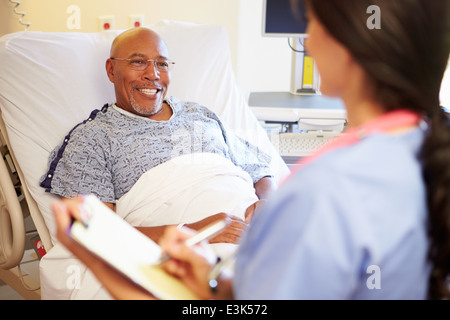 Close Up Of Nurse Updating Patient Notes Stock Photo
