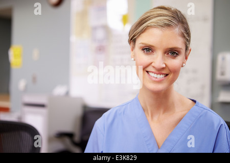 Portrait Of Female Nurse Working At Nurses Station Stock Photo