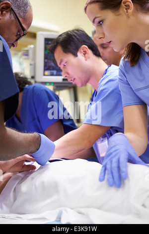 Medical Team Working On Patient In Emergency Room Stock Photo