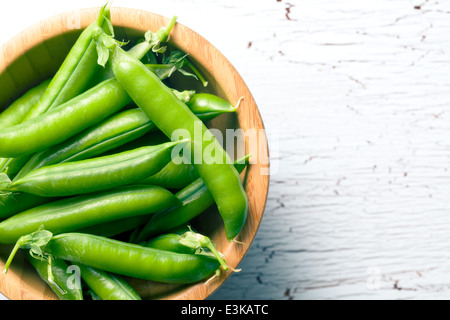 Fresh green pea in cracked - open pod on white background - close up ...