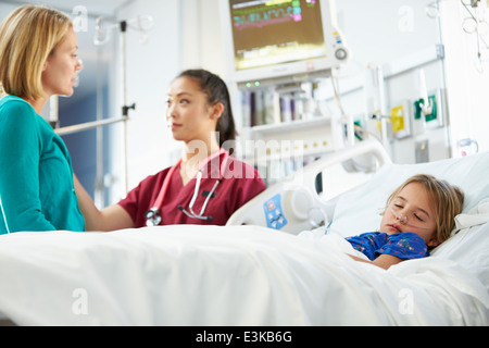Mother And Daughter With Nurse In Intensive Care Unit Stock Photo