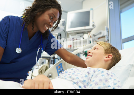 Boy Talking To Female Nurse In Emergency Room Stock Photo