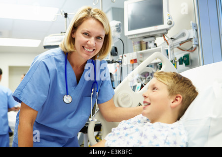 Boy Talking To Female Nurse In Emergency Room Stock Photo