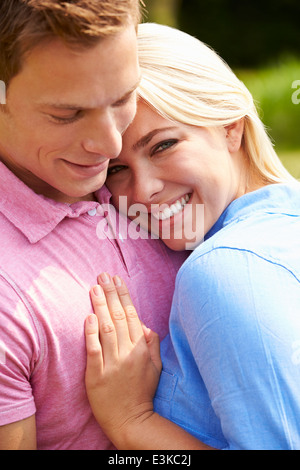 Romantic Young Couple Hugging In Garden Stock Photo