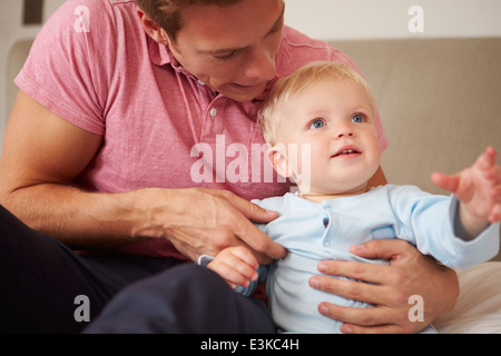 Father Playing With Young Son Indoors Stock Photo